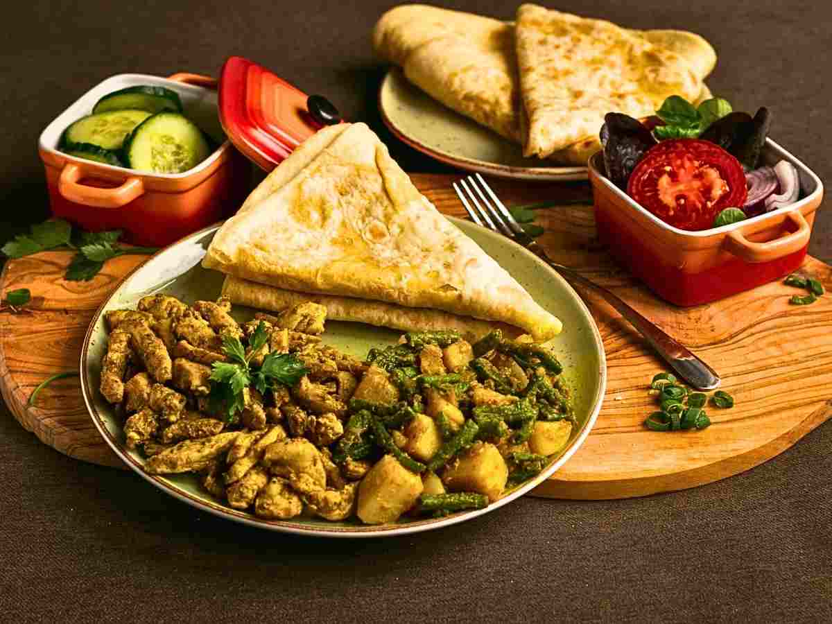 Surinamese roti served with spicy Surinamese chicken curry served on a plate