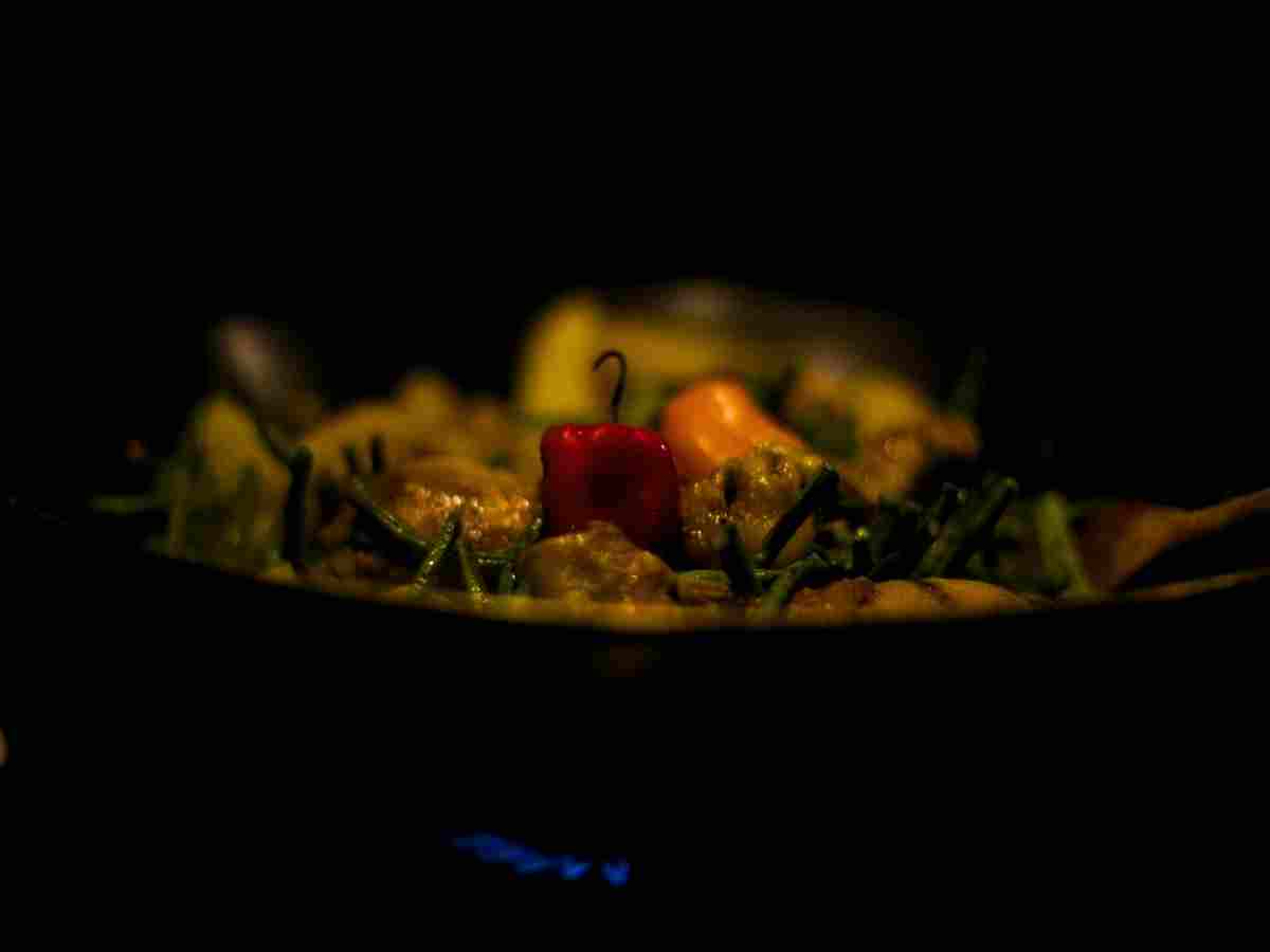 a platter of Surinamese food set in a dark background