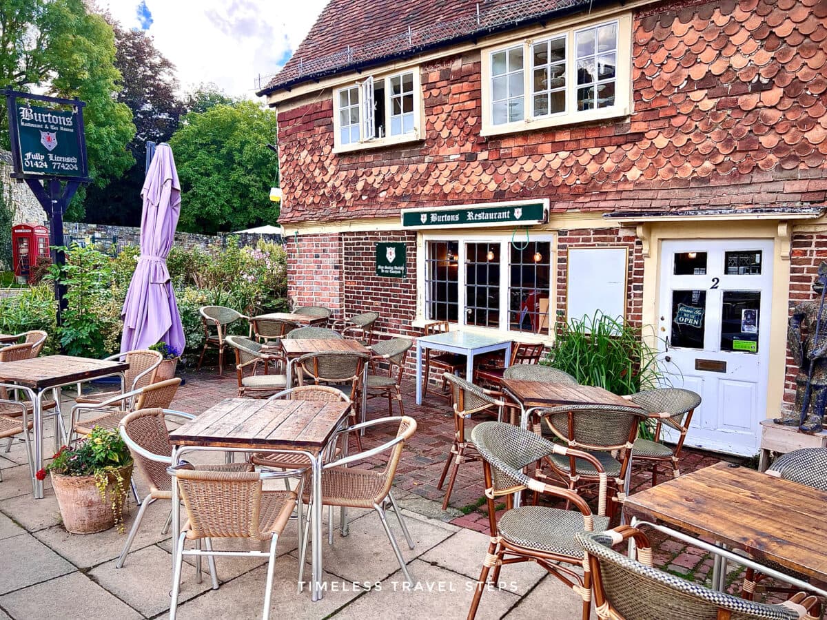 Front view of Burton’s Restaurant with outdoor seating and parasols on Battle High Street, East Sussex