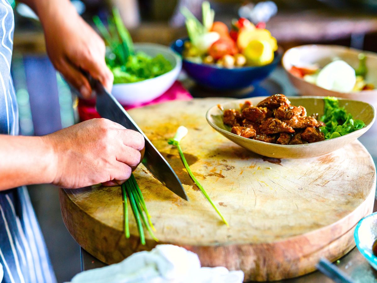 a chef showcasing a traditional meat dish in Cambodia | Guide to Sustainable Travel for Heritage and Culture Explorers + Tips