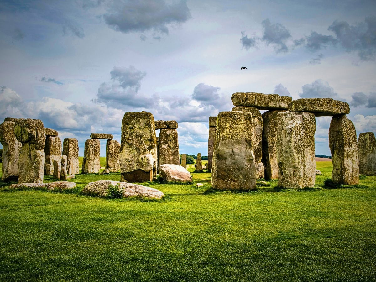 The secrets of Stonehenge revealed: iconic sarsen stones standing on Salisbury Plain under a slightly cloudy sky.