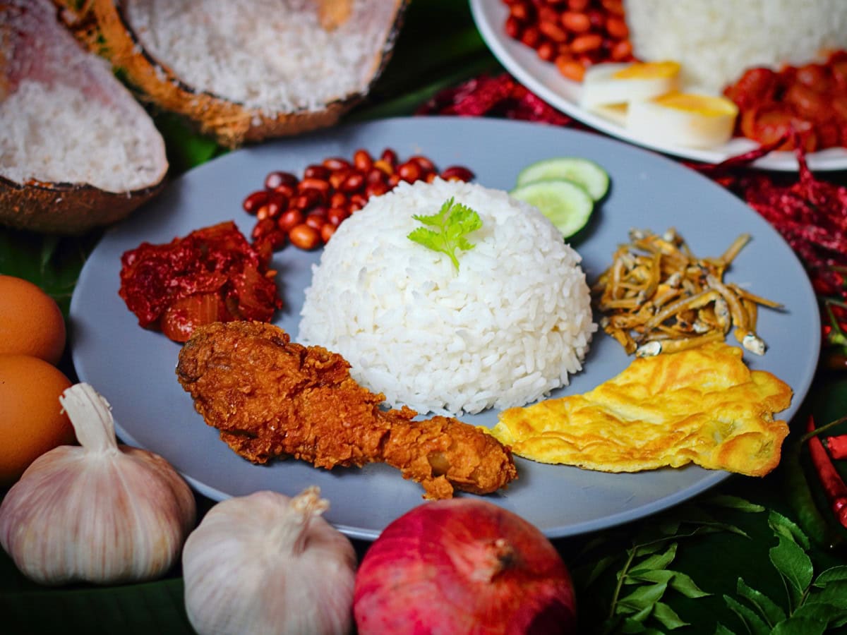 Nasi lemak served with a fried egg, coconut rice, and sambal, a simple and popular variation of Malaysia’s iconic dish.